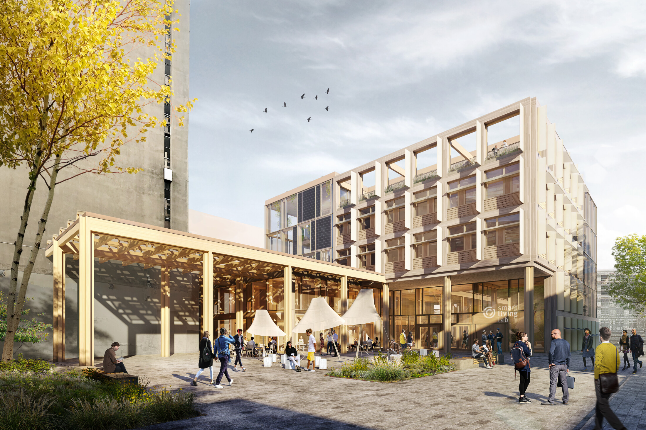 Project by Behnisch Architekturbuero, Smart Living Lab. Modern building with covered outdoor area, sun sails and a public space where many people come together and interact.