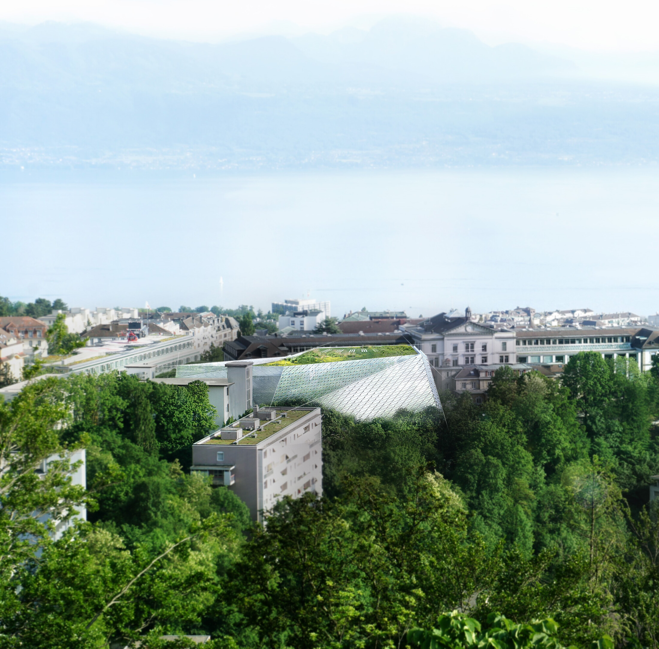Project by Behnisch Architekturbuero, AGORA Pôle de recherche sur le cancer. Elevated view of a town with trees and rooftops, featuring a modern glass-roofed building, with a large lake and mountains in the background.